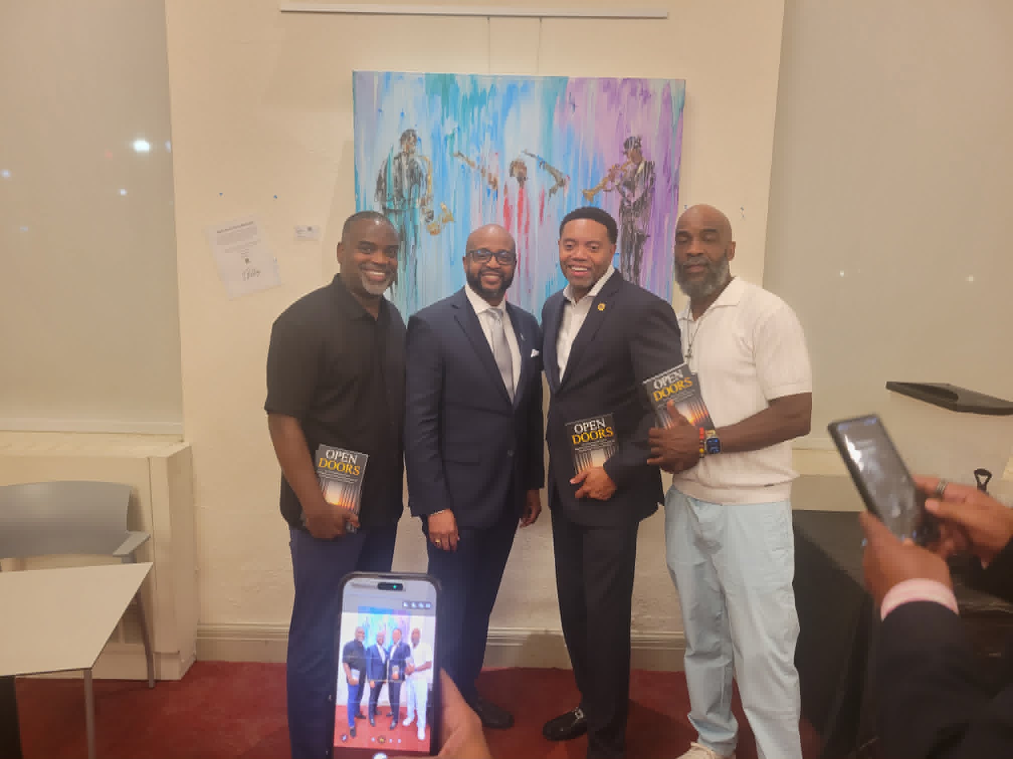 Dr. Kester Crosse with brothers holding copies of Open Doors